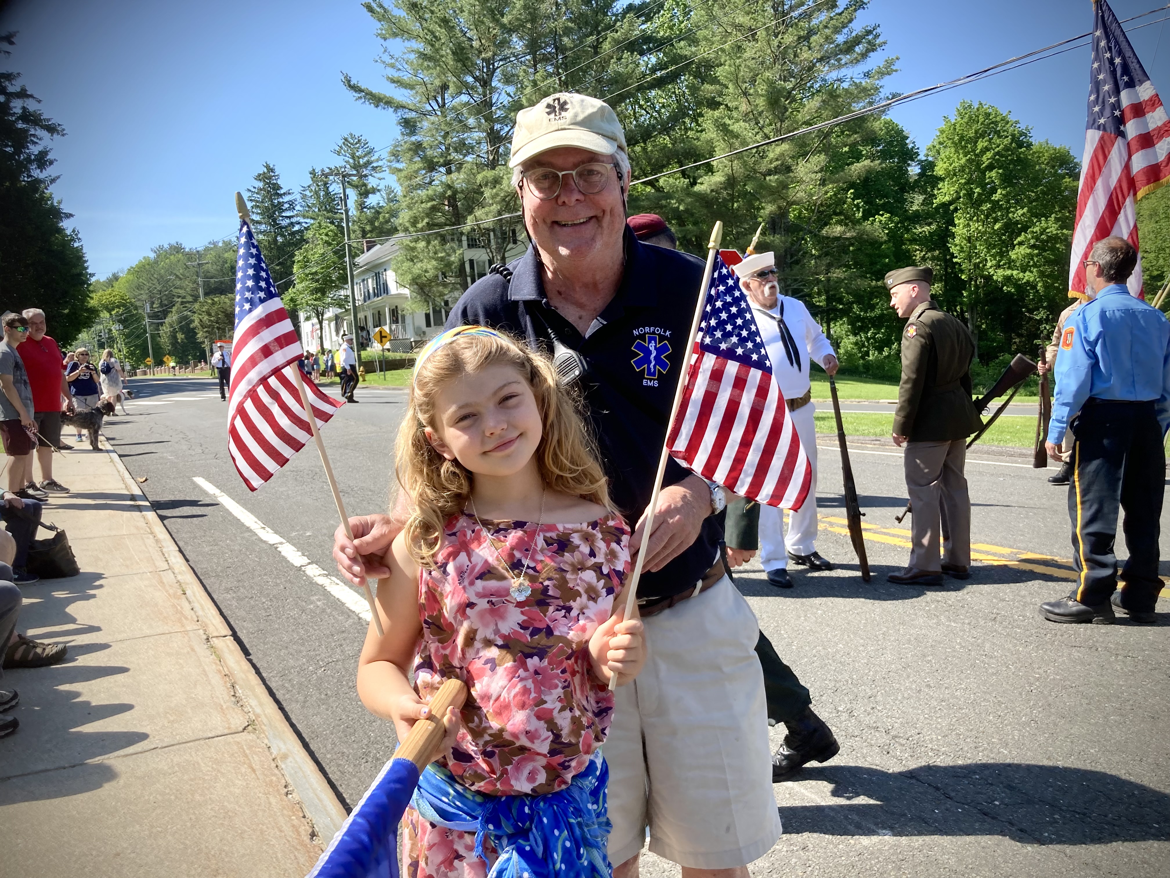 Volunteer with young community member at parade